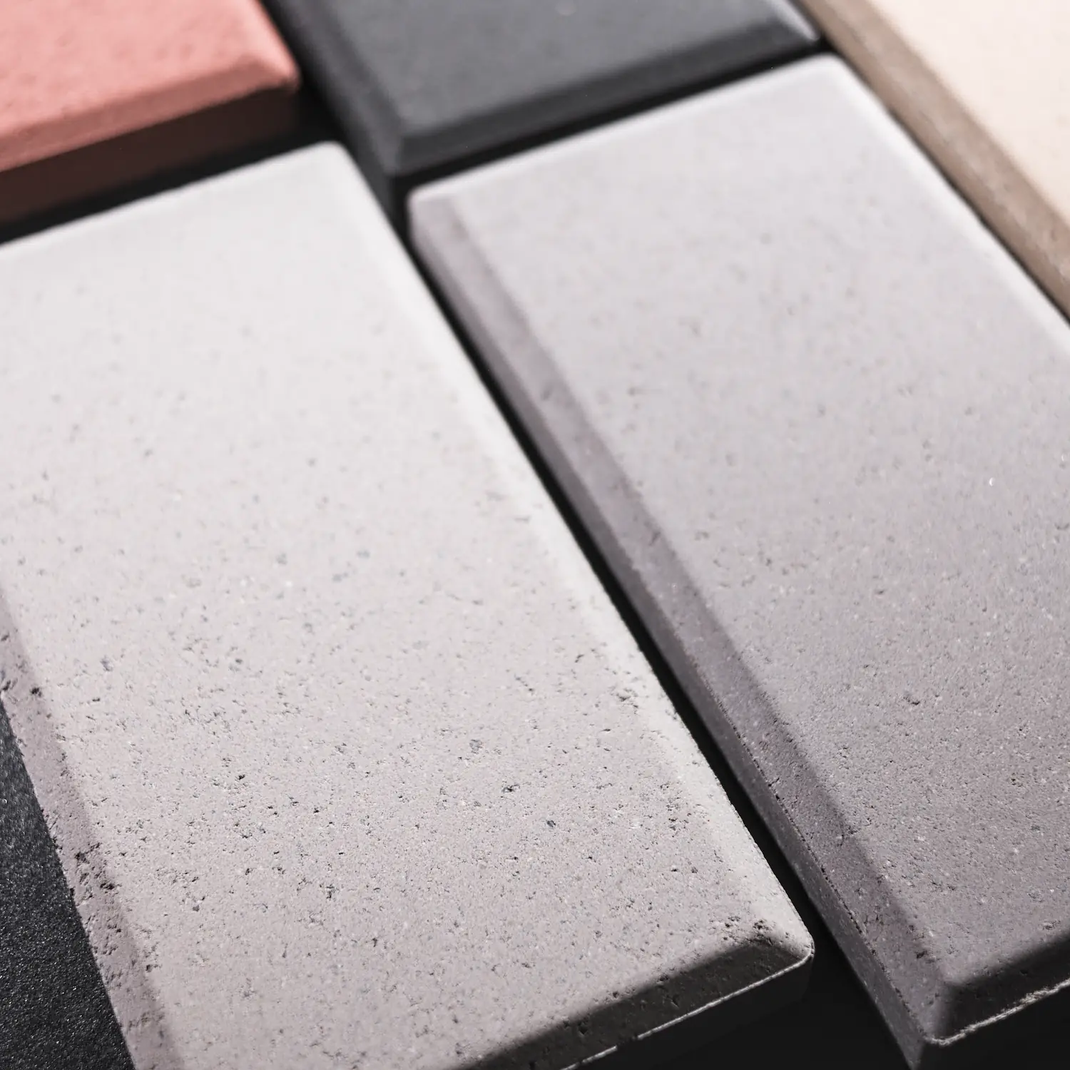 Slim profile outdoor tiles Close-up of 18 mm slim-profile outdoor tiles showing bevelled edges and mineral texture