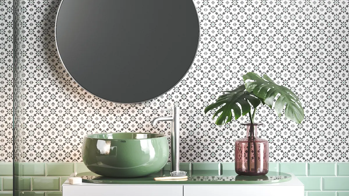 Bathroom wall with decorative tiles in white background and floral design in shades of gray and green
