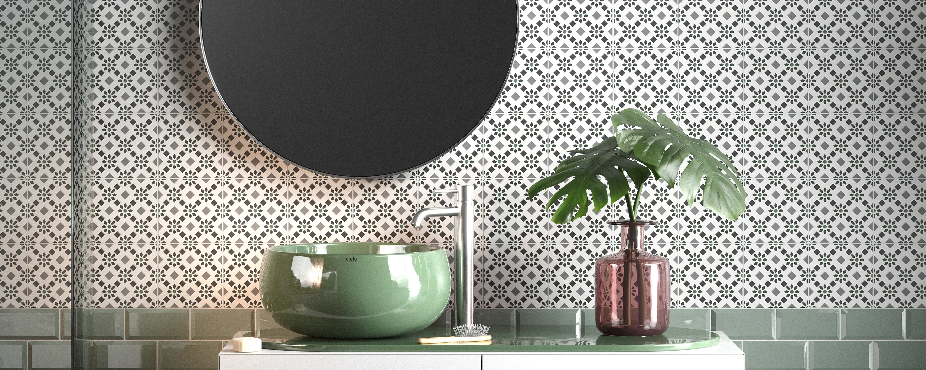 Mur de salle de bains avec carreaux de ciment décoratifs à motif botanique blanc et vert, associés à des carreaux métro et à un lavabo dans des tons de vert