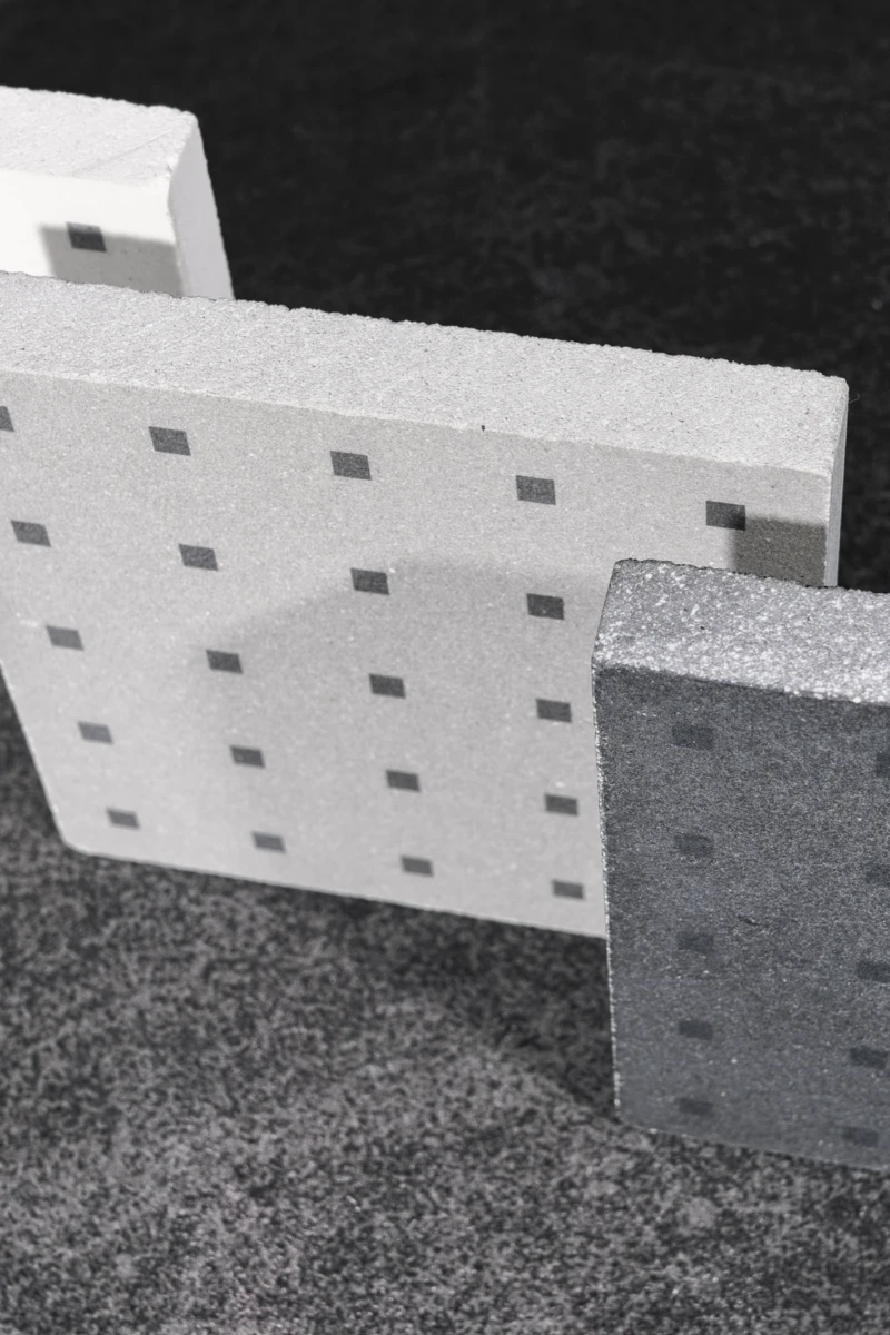 Design wall coverings and flooring tiles in white, grey and black cement.